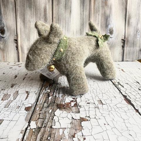 Textured dog figurine on a rustic wooden surface