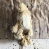 Textured gnome figure against a wooden background