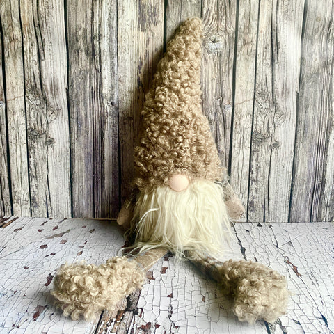 Textured gnome figure with a wooden background