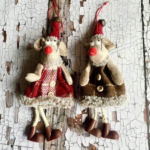 Two decorative mice tree ornaments on a textured white and brown background