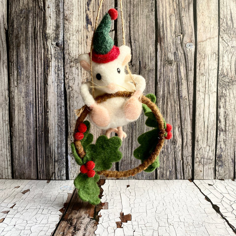 Felted mouse ornament with green hat and red berries on a wooden background