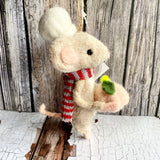 Stuffed chef mouse toy with a striped scarf and carrot against a wooden background