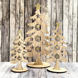 three little wooden Christmas trees