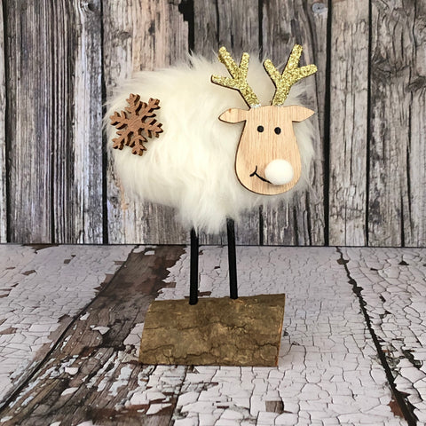 Wooden reindeer with a white fur coat